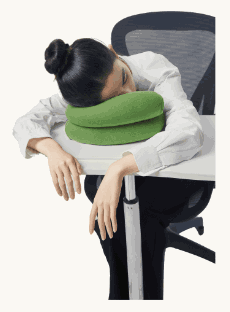 Resting face-down on the folded pillow at a desk